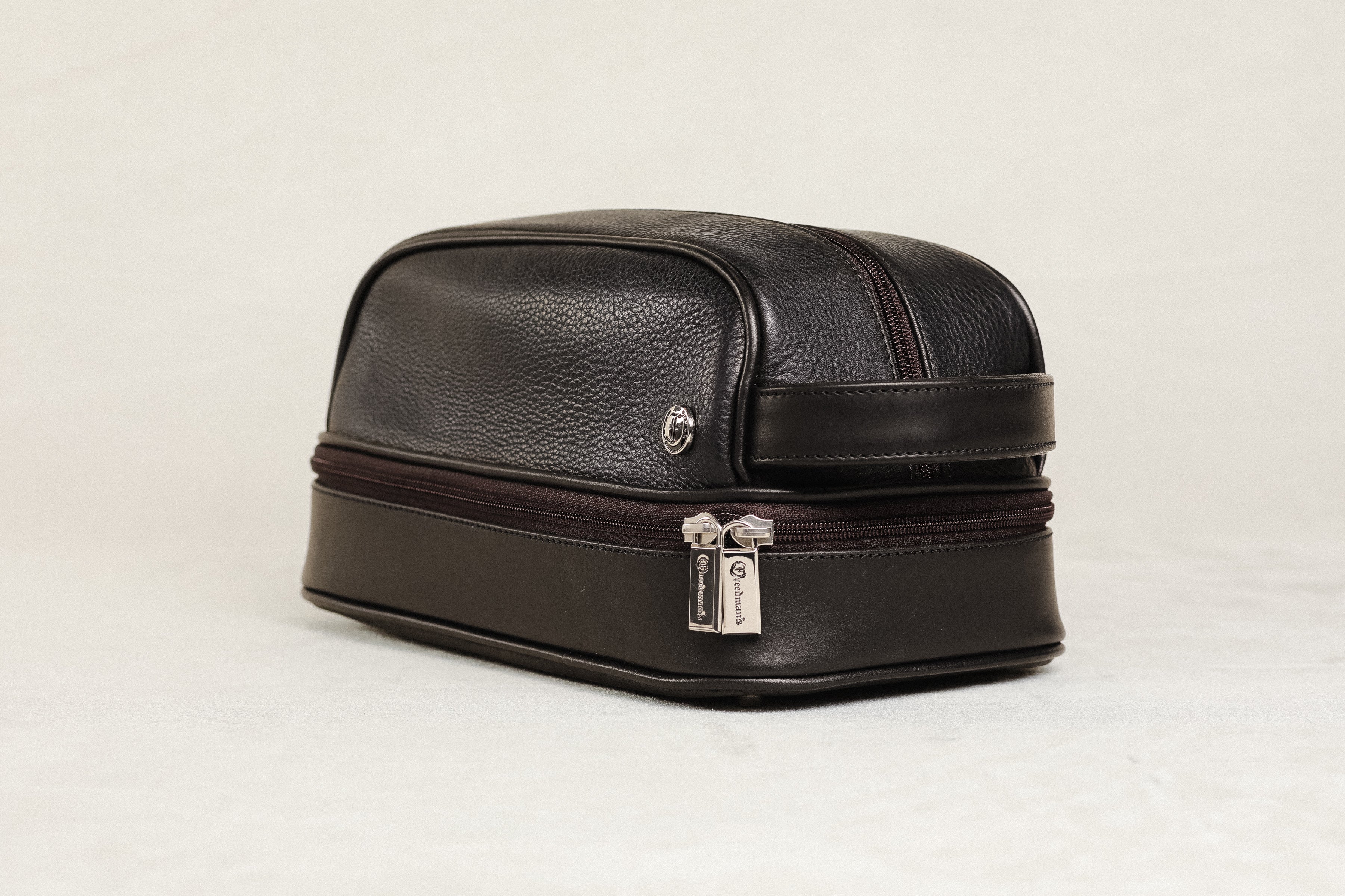 Freedman's Cardiff Shave Bag, Brown Textured Leather, Dual Zippered Compartments. Embossed Logo Pattern, Silver Hardware, and Side Handle