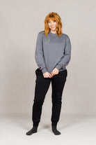 Woman wearing the Ash Grey Freedman's embroidered crewneck sweatshirts. These stylish and cozy sweatshirts feature a tonal Freedman’s logo, perfect for casual wear and layering