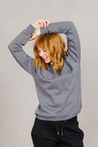 Woman wearing the Ash Grey Freedman's embroidered crewneck sweatshirts. These stylish and cozy sweatshirts feature a tonal Freedman’s logo, perfect for casual wear and layering