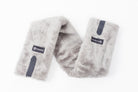 Close-up of Freedman's Fleece Breast Collar Pad, grey fabric with logo patches, equestrian equipment.