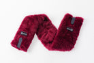 Close-up of Freedman's Fleece Breast Collar Pad, burgundy  fabric with logo patches, equestrian equipment.