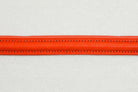 Close-up of Red leather of the Raised Dog Leash showing detailed stitching.
