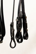 Close-up of Black Leather Reins with Buckle Attachments for Horse Bridle