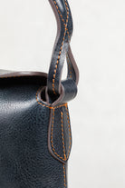 Close-up of Freedman's Murphy Bag Handle, Dark Navy Leather with Visible Orange Stitching and Hardware Attachment