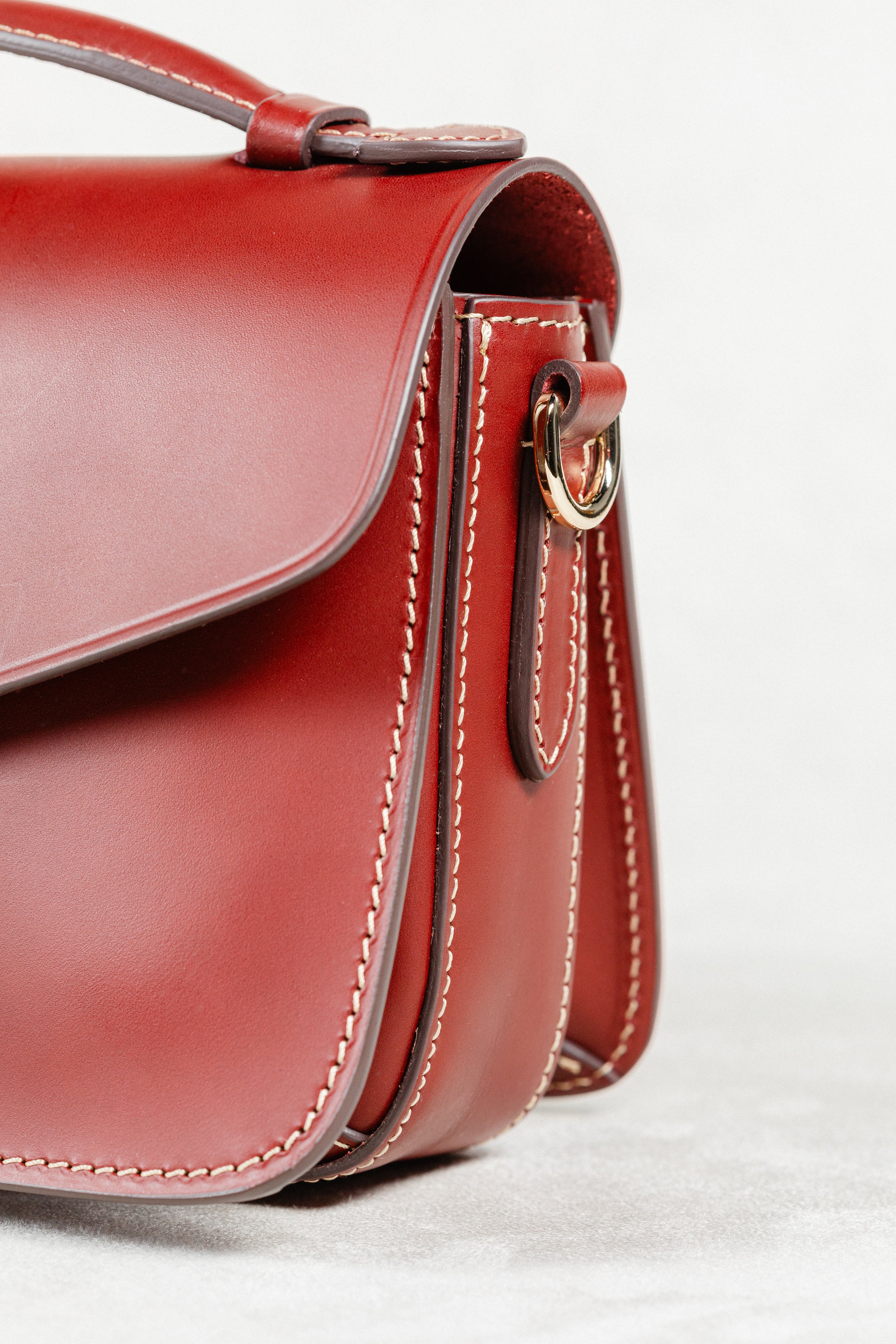 Close-up of Brunello leather Mantelet Bag by Freedman's, showing side profile, gold-tone hardware, and stitching details.