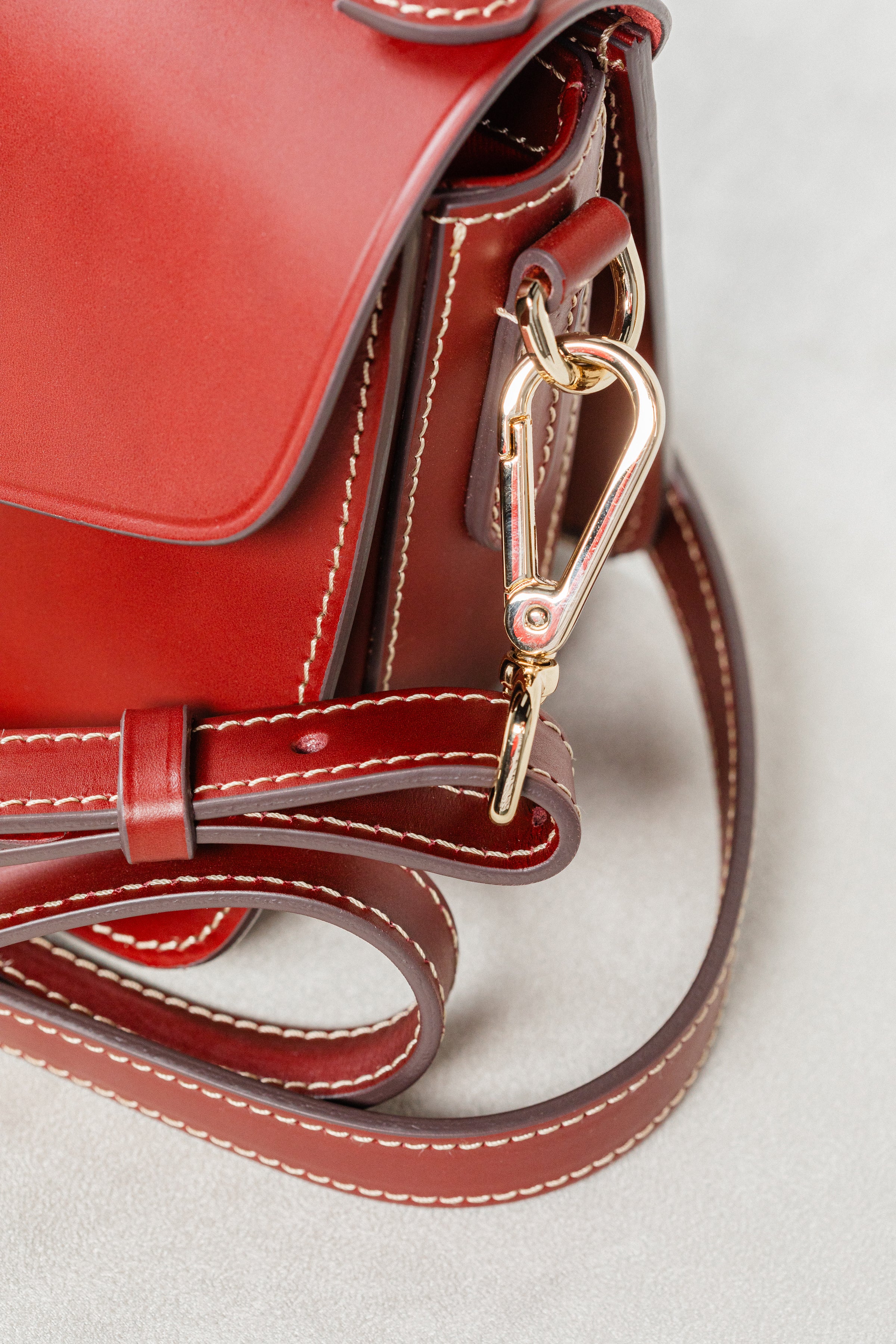 Close-up of Brunello leather Mantelet Bag by Freedman's, highlighting gold-tone clasp hardware, adjustable strap, and contrasting stitching.