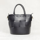 Freedman's Milord Bag in black leather, back view, highlighting woven texture, structured handles, and gold-tone hardware.