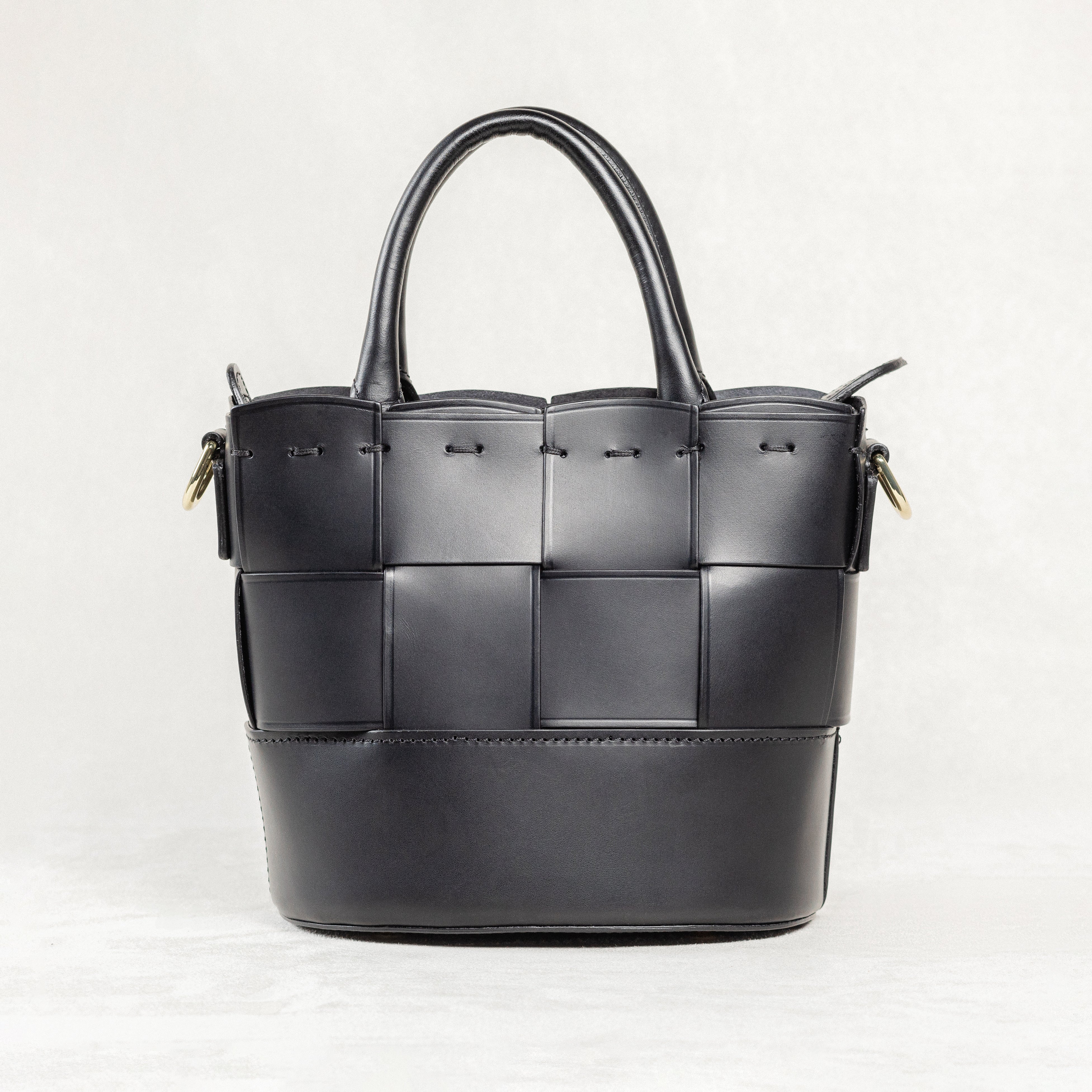 Freedman's Milord Bag in black leather, back view, highlighting woven texture, structured handles, and gold-tone hardware.