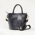 Front view of black leather Milord Bag by Freedman's, showing woven design, gold-tone hardware, and adjustable strap.
