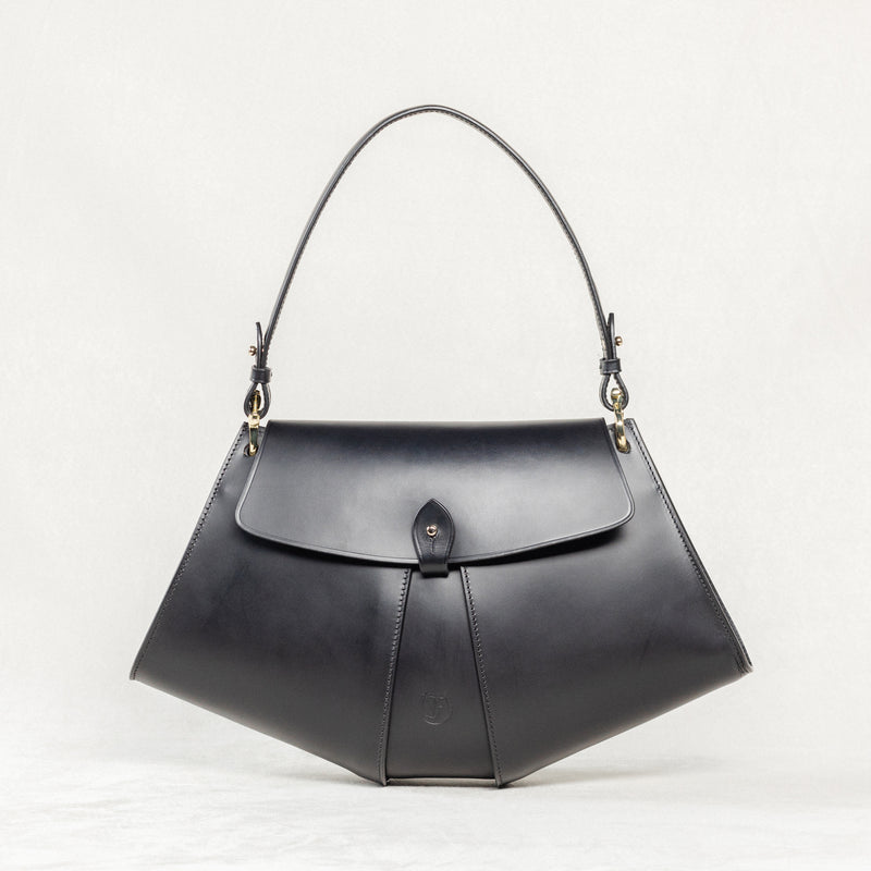 Freedman's Moray Bag, black leather with a distinctive geometric shape, single flap closure, and embossed brand logo.
