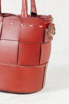 Alt text: Close-up of Brunello leather Milord Bag by Freedman's, highlighting gold-tone zipper, ring hardware, and handle stitching.
