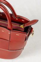 Close-up of Brunello leather Milord Bag by Freedman's, highlighting gold-tone zipper, ring hardware, and handle stitching.