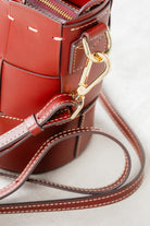 Close-up of Brunello leather Milord Bag by Freedman's, highlighting gold-tone clasp hardware and adjustable strap attachment.
