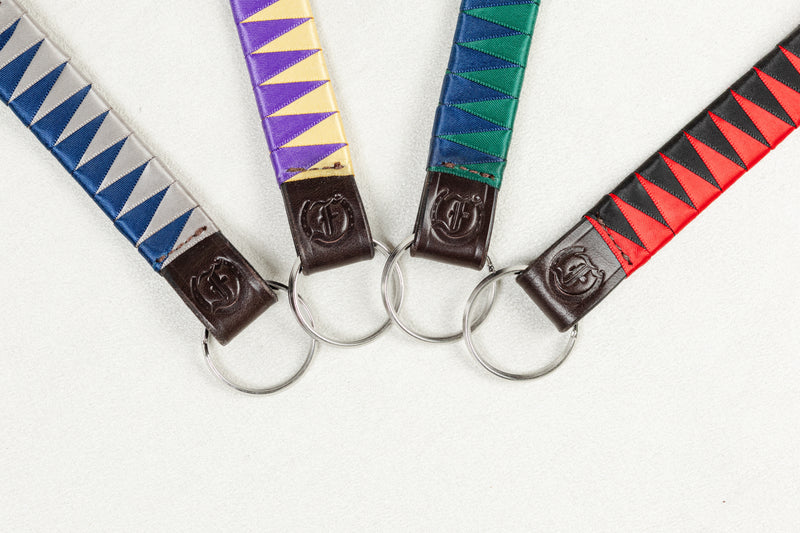 Assorted satin browband leather keychains in blue, purple, green, and red with stainless steel rings and embossed Freedman’s F logo on a white background.