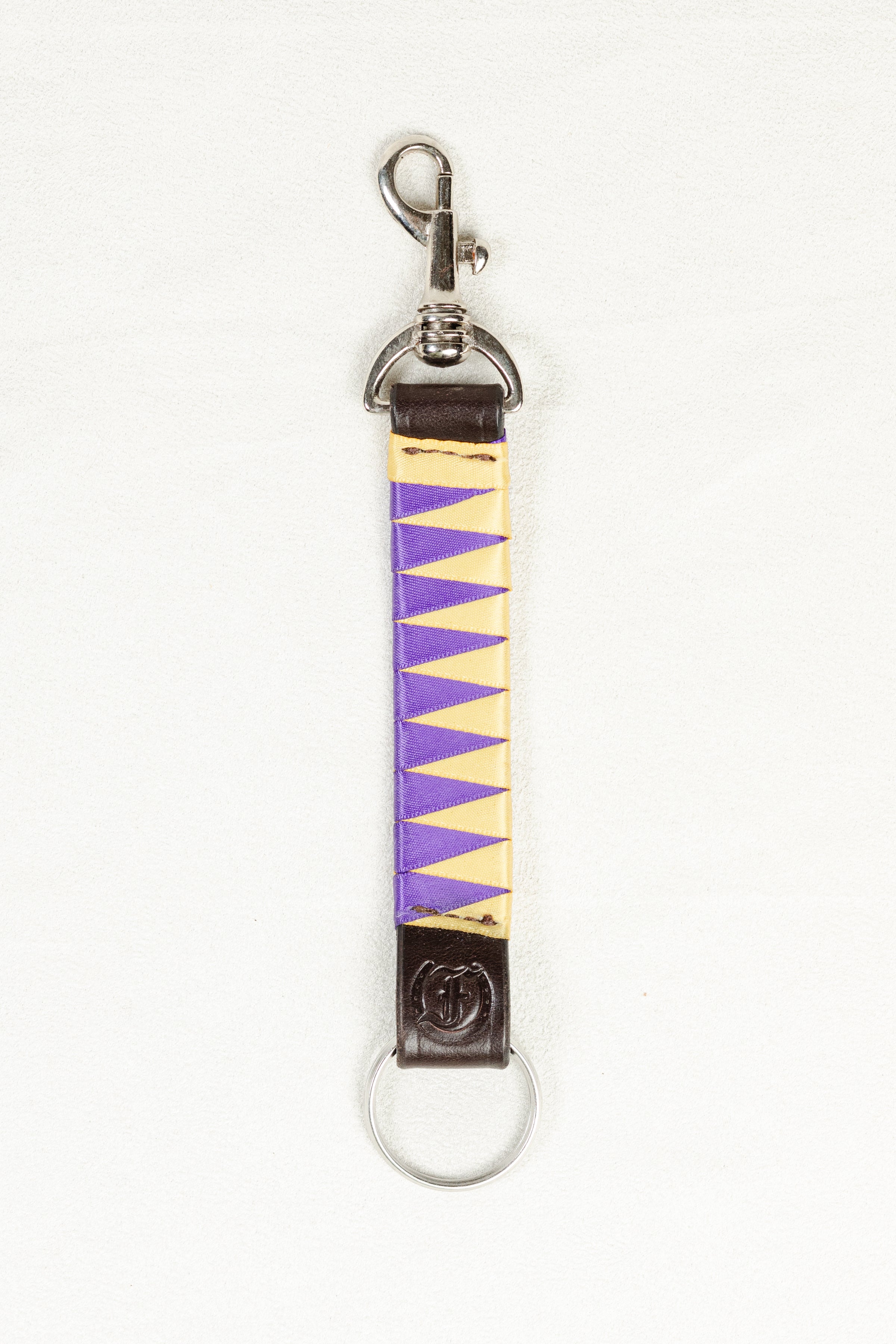 Purple and Yellow satin-finished keychain in dark Havana brown bridle leather with stainless steel clasp and Freedman’s F logo on a white background.