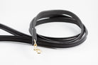 Close-up of black leather Raised Dog Leash showing gold clasp and detailed stitching.
