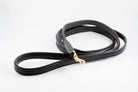 black leather Raised Dog Leash showing gold clasp and detailed stitching.
