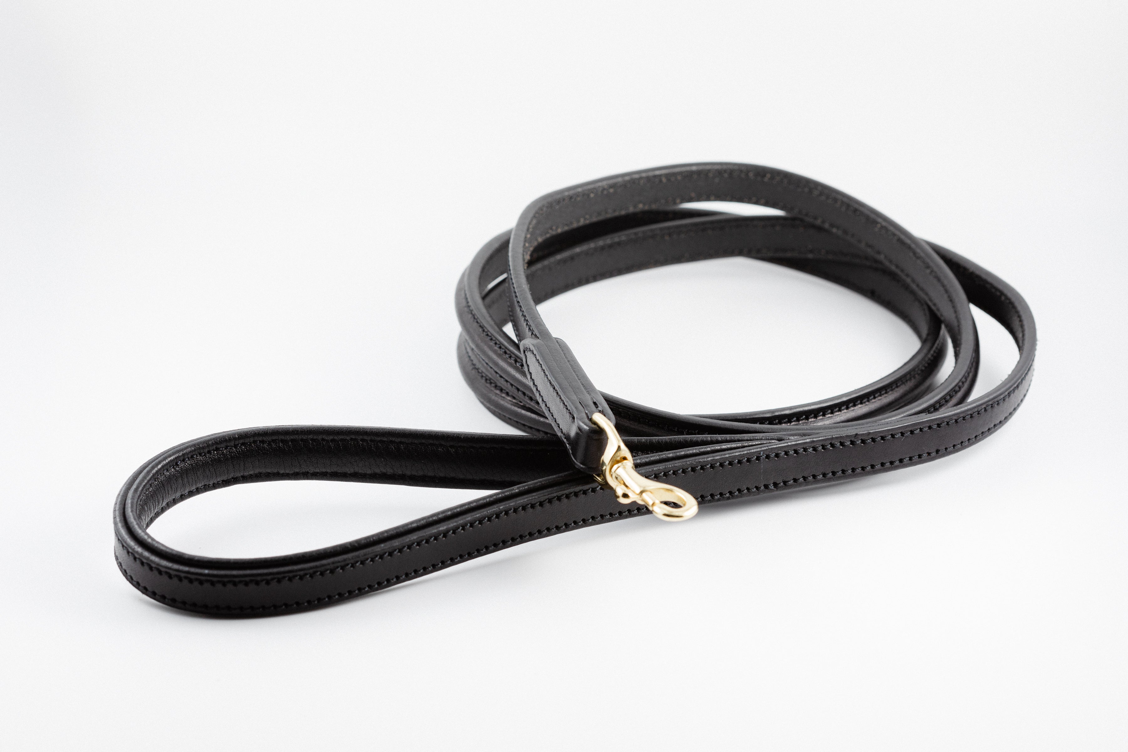 black leather Raised Dog Leash showing gold clasp and detailed stitching.

