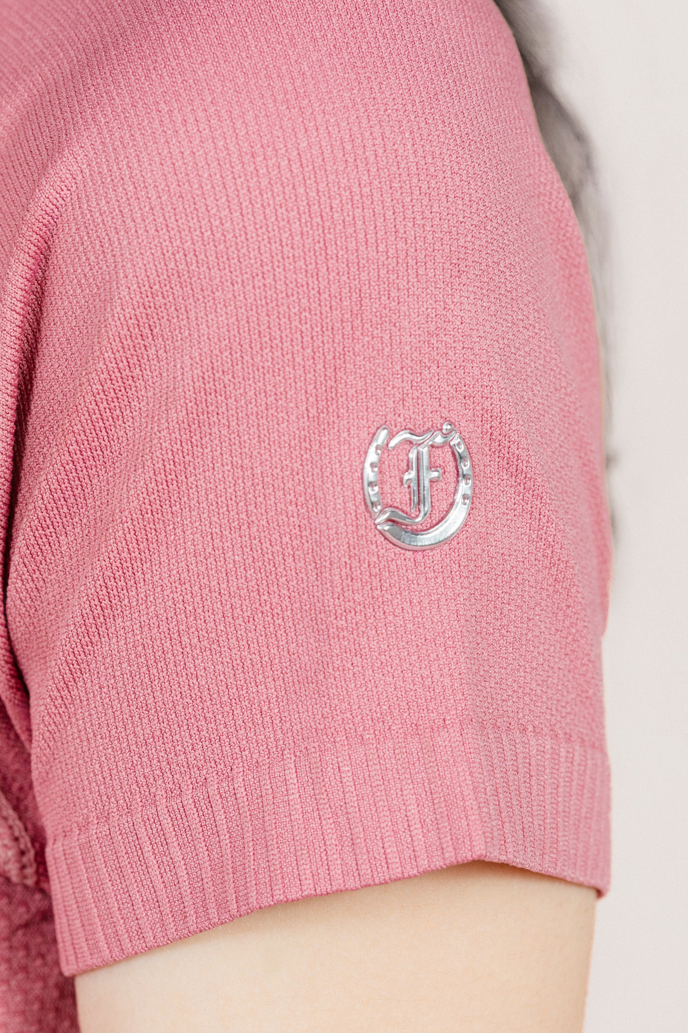 Close-up of Pink Seamless T-shirt
 cuff with small silver Freedman's logo.