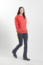 Woman wearing the Brick Red Freedman's embroidered crewneck sweatshirts. These stylish and cozy sweatshirts feature a tonal Freedman’s logo, perfect for casual wear and layering