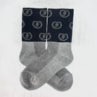 Two-tone gray and black socks with repeating Freedman's logo, laid flat with visible details and pattern
