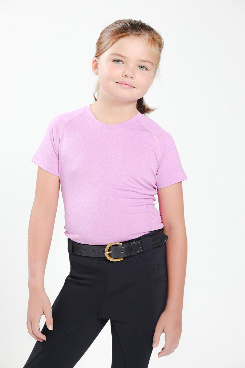 A young girl wearing the Kid's Horseshoe Buckle Belt: Black Leather Belt with Gold Horseshoe Buckle and Freedman’s Brand Inscription with Pink t-shirt and black pants
