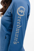 Close-up of Ladies Arum Jacket  in Blue Showing Freedman's Logo and Arm Detail.