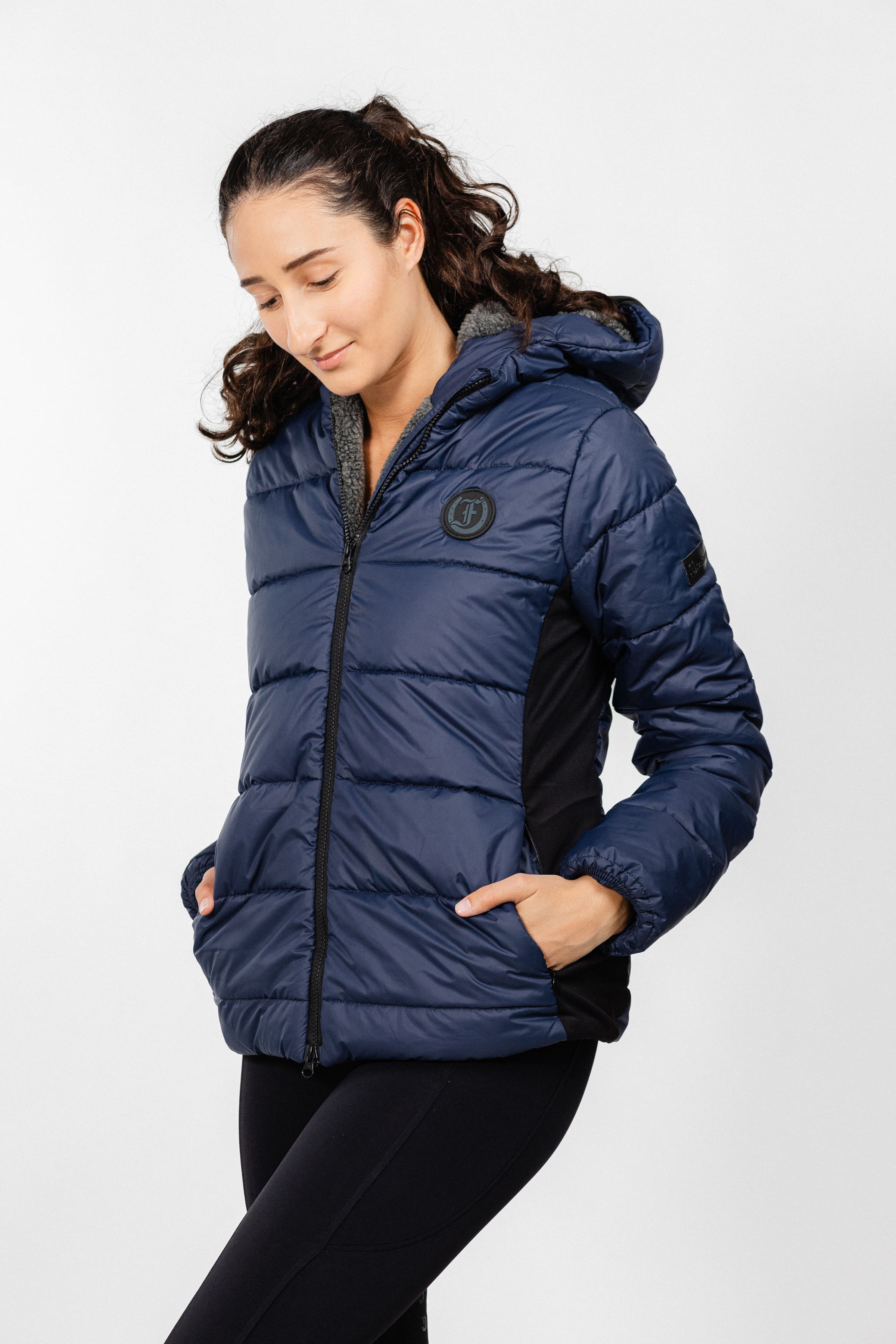 Navy blue Ladies Winter Bomber Jacket by Freedman's, featuring a quilted puffer design and visible logo.