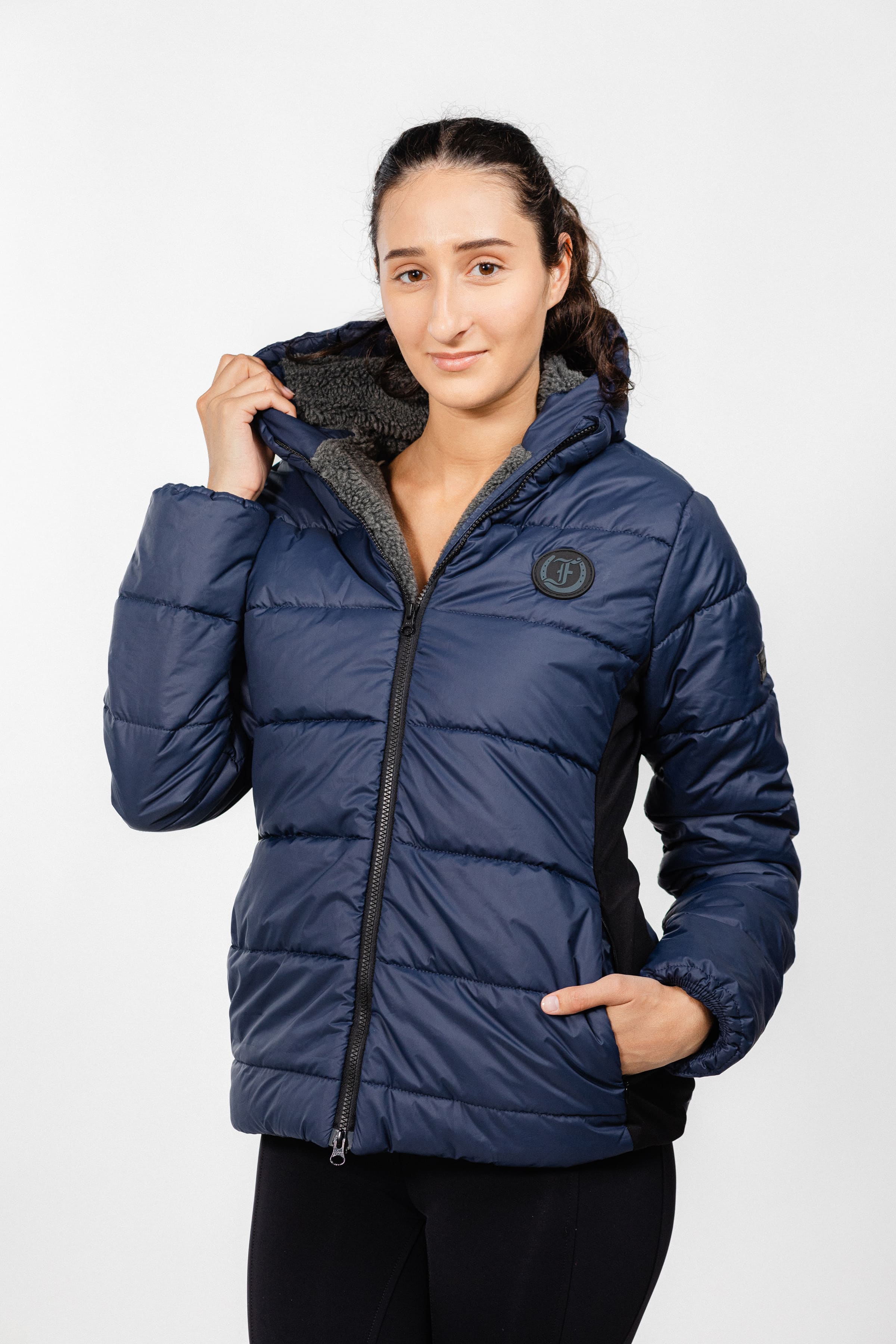 Navy blue Ladies Winter Bomber Jacket by Freedman's, featuring a quilted puffer design and visible logo