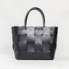 Black Manalos Bag by Freedman's, featuring a woven leather design and structured handles.