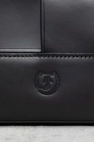 Close-up of Freedman's F logo embossed on the Manalos Bag
