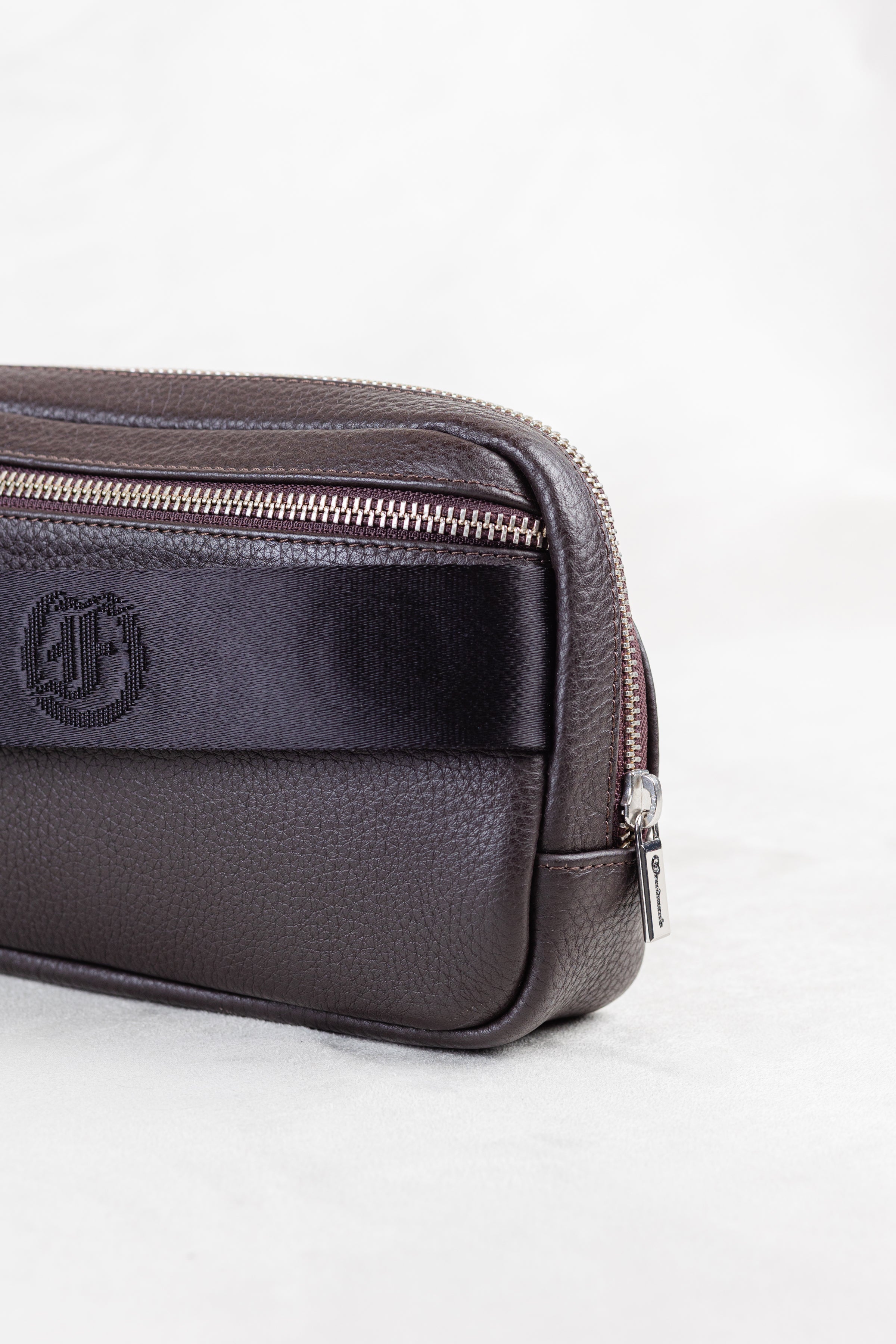 Brown leather crossbody or waist bag with a visible brand logo on white background