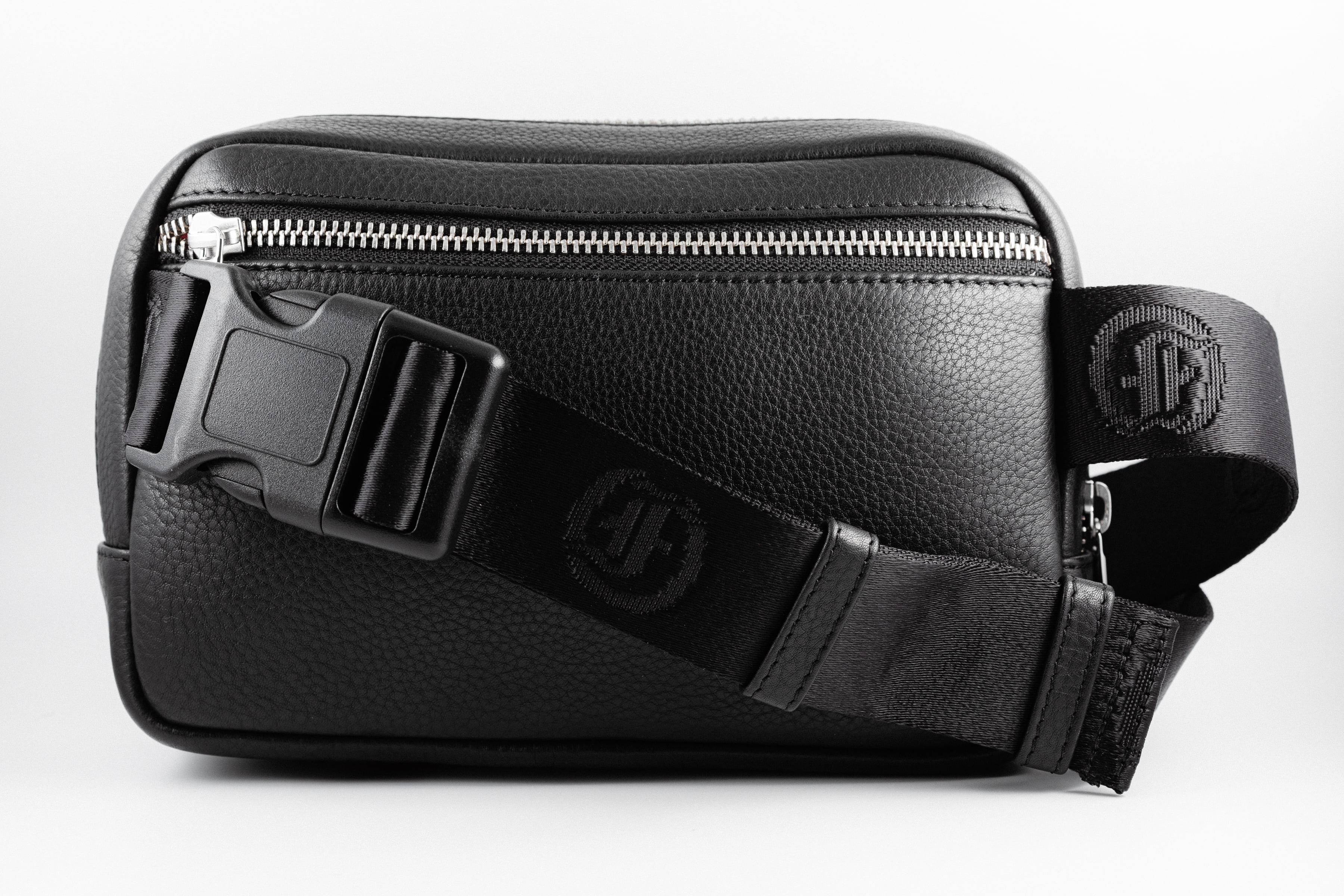 Black leather belt bag with adjustable strap and buckle closure.
