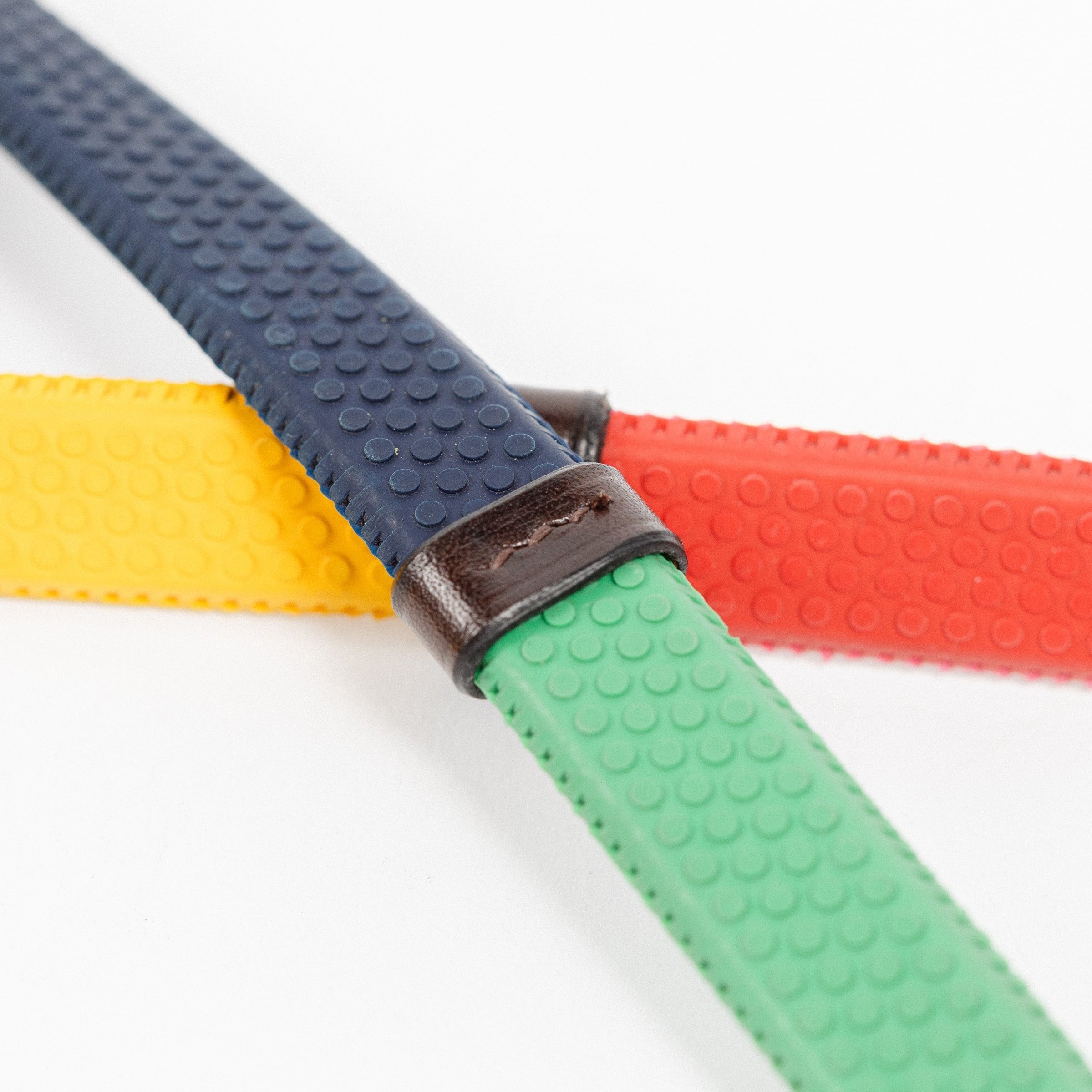 Close-up of Rainbow Training Reins showing textured rubber grip and leather connection points.