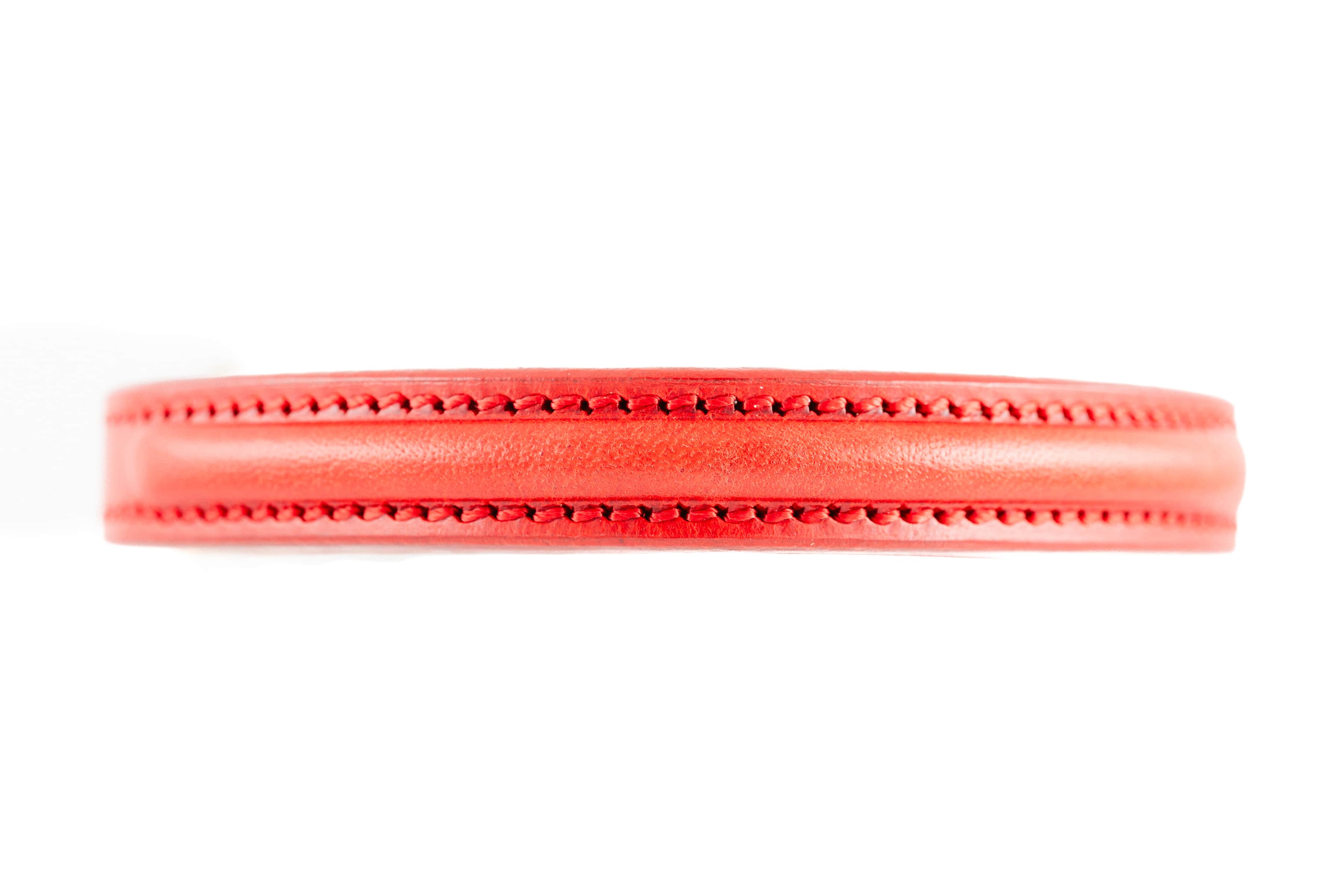 Close-up of Raised Dog Collar in red leather, showing detailed stitching on white background.