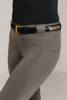 Raised Custom Name Plate Belt in black leather with gold buckle and "FREEDMAN'S" nameplate, worn with grey equestrian riding pants.