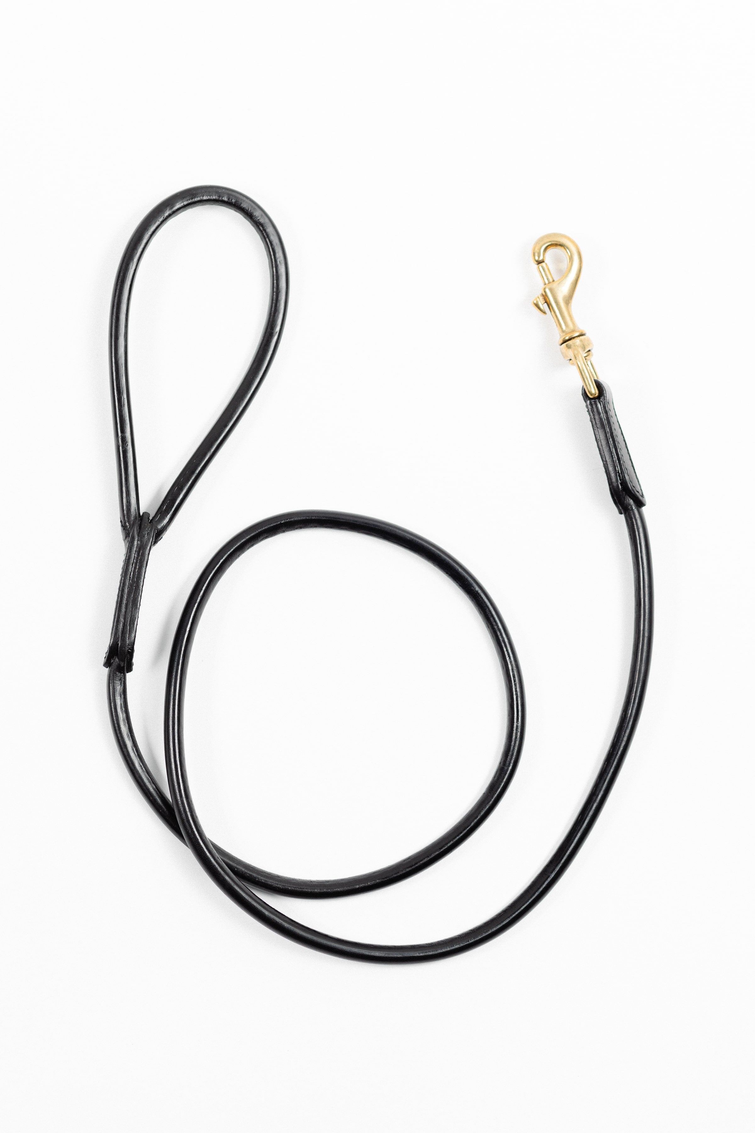 Black leather dog leash with a gold clasp, shown from above on a white background.
