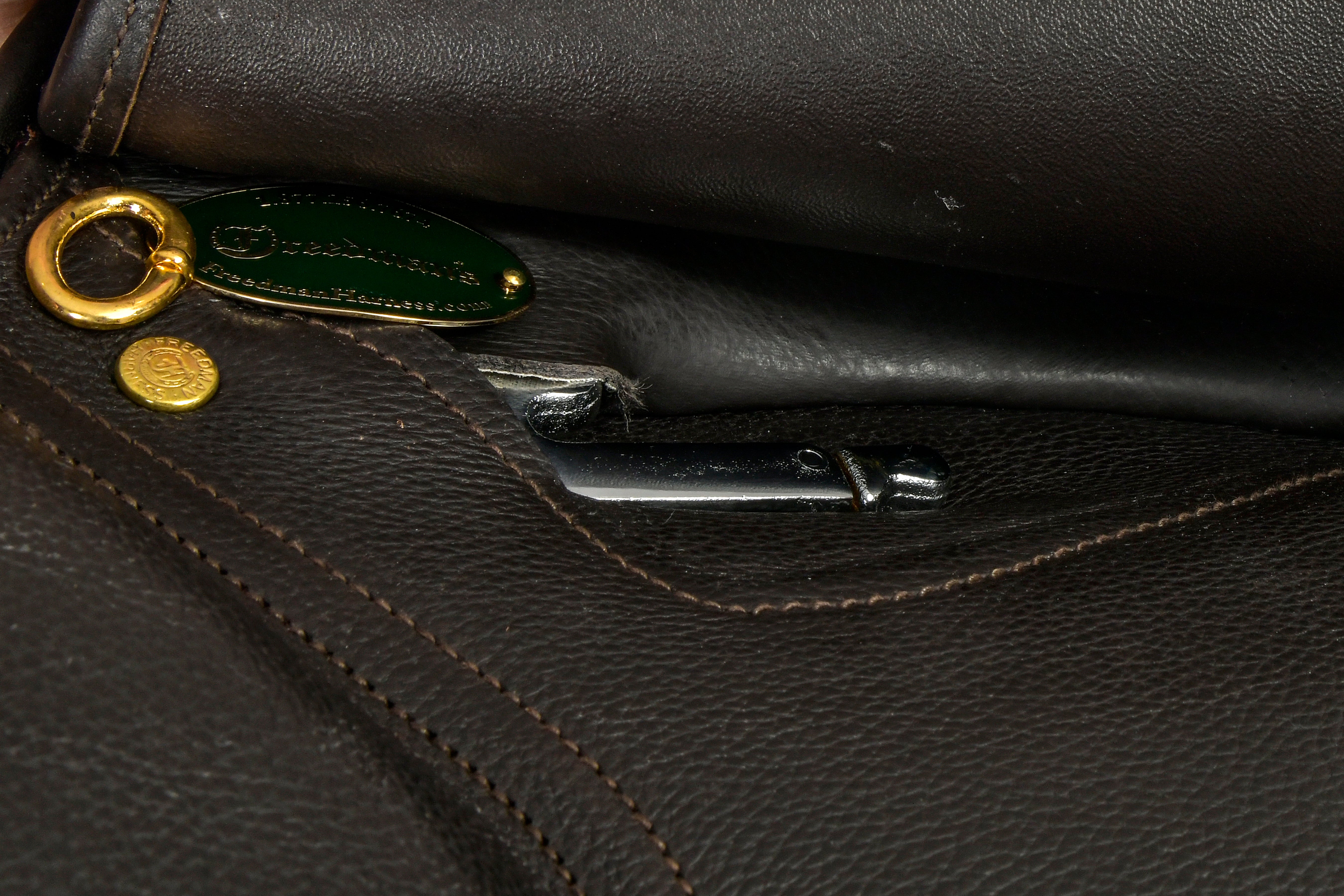 Close-up of Centennial Hunter Saddle hardware and branding.

