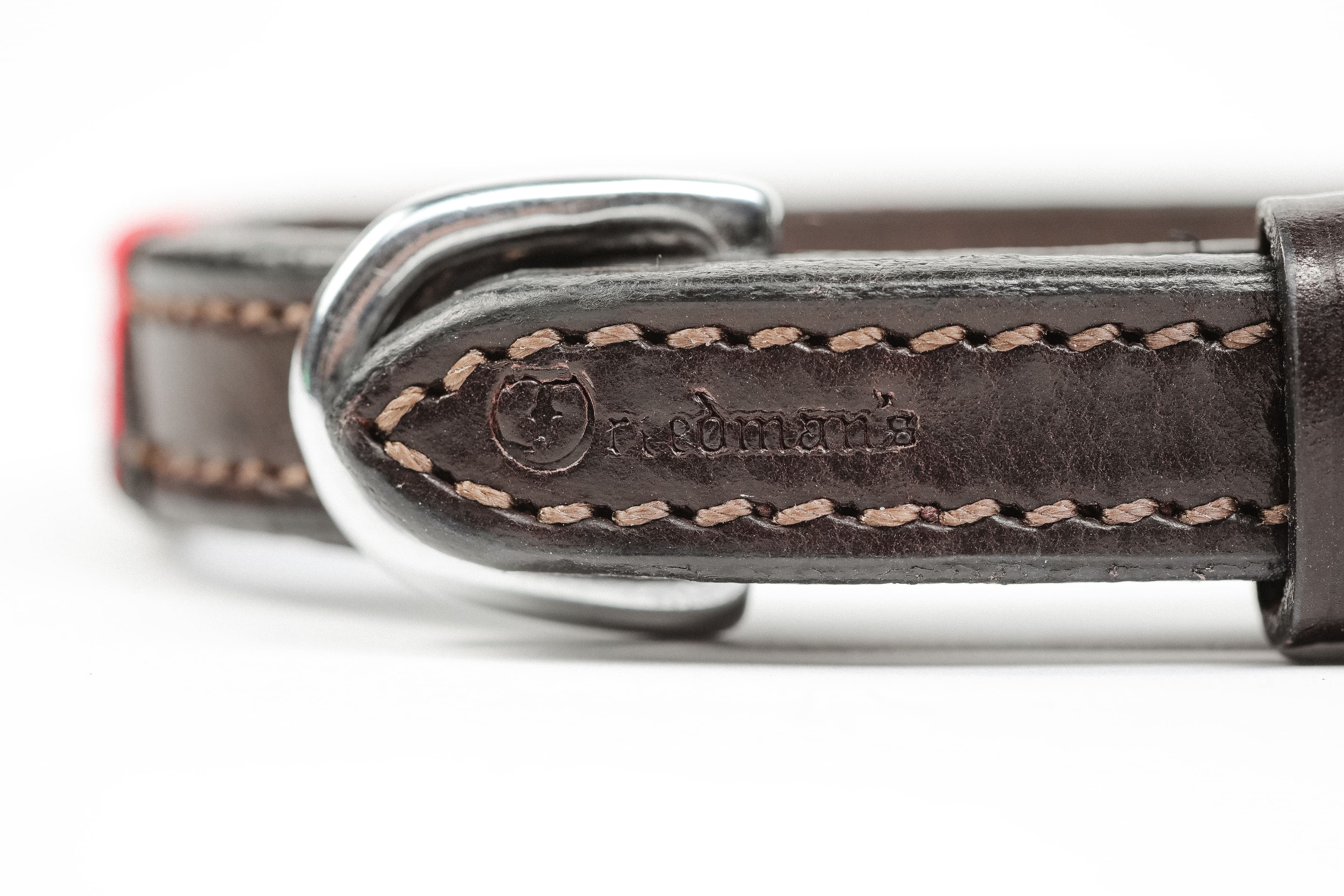 Close-up of Satin Red and Black Weaved Dog Collar showing leather detail, silver hardware, and "Freedman's" brand embossing.