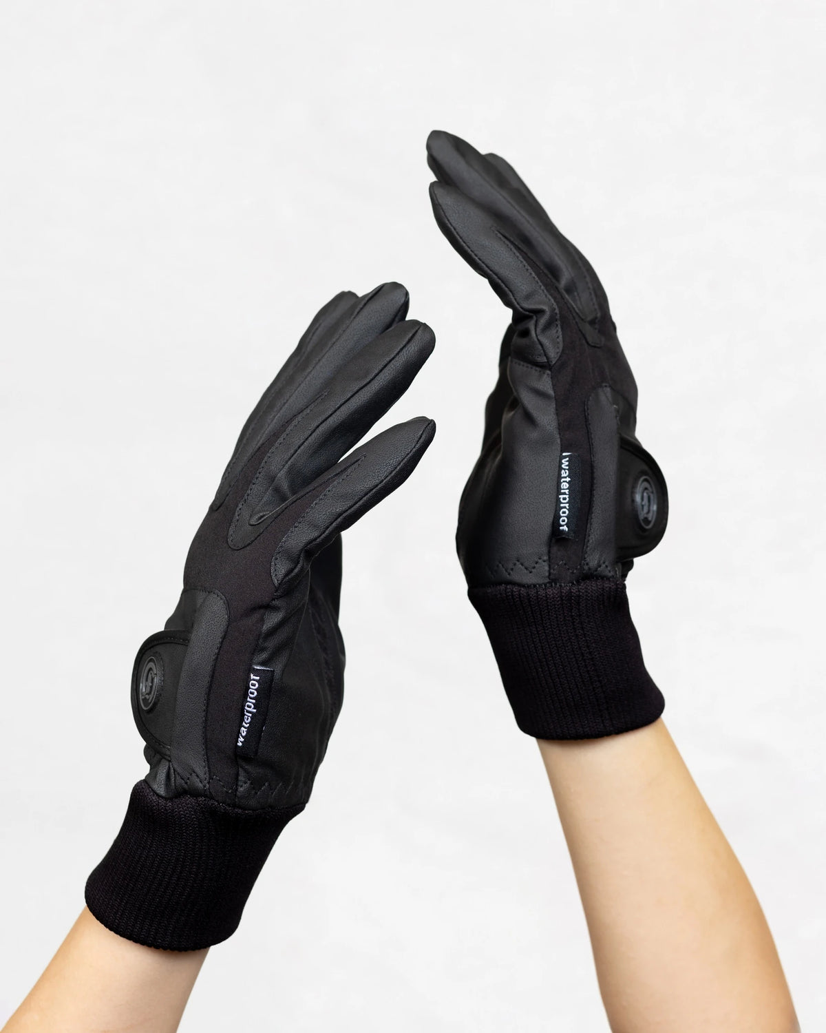 Signature Ladies' II Winter Gloves in black shown on hands, highlighting the waterproof design, adjustable wrist straps, and extended knit cuffs.
