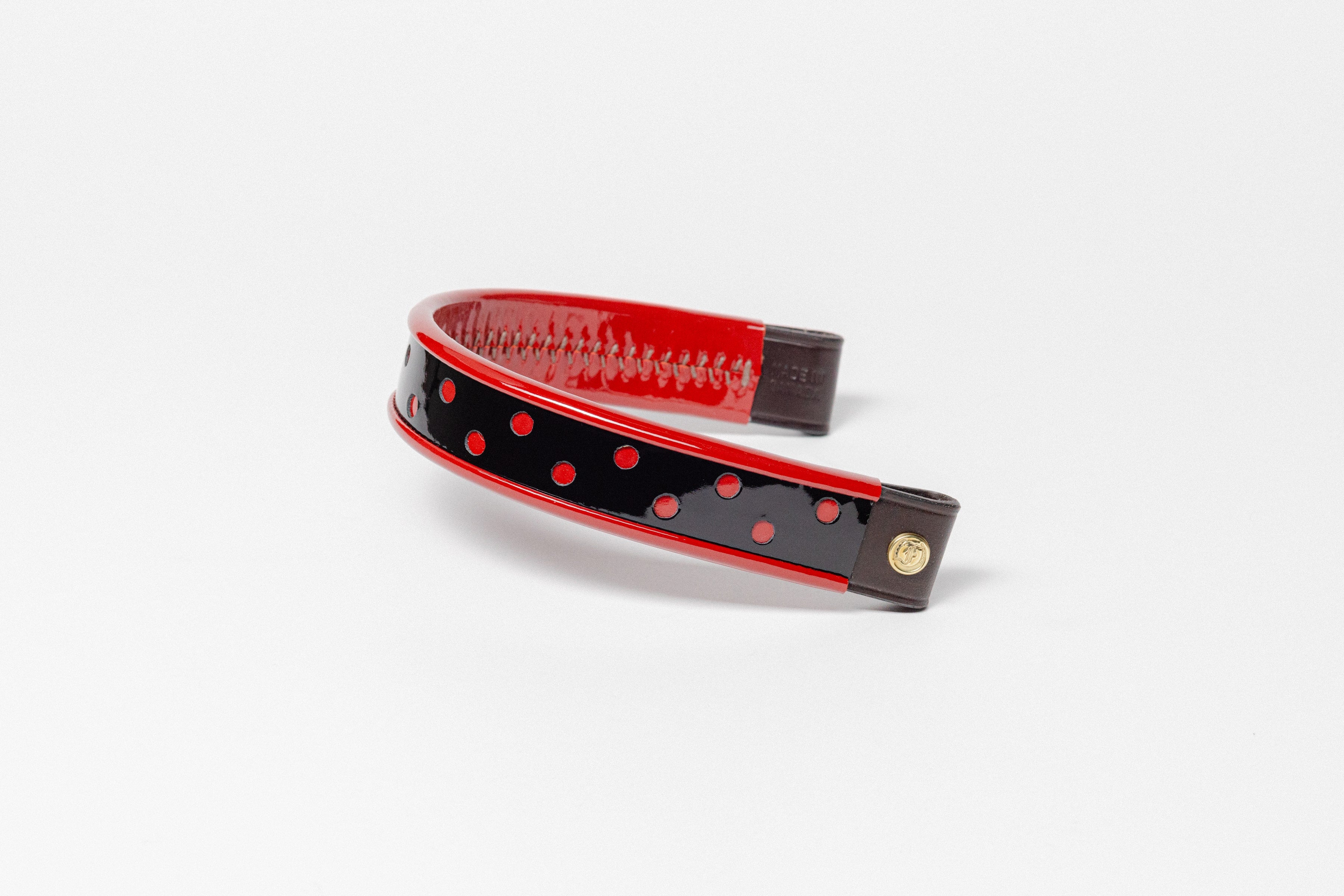 Wide Tapered turned edge browband, black patent, red dots, dark brown ends with Brass "F" logo
