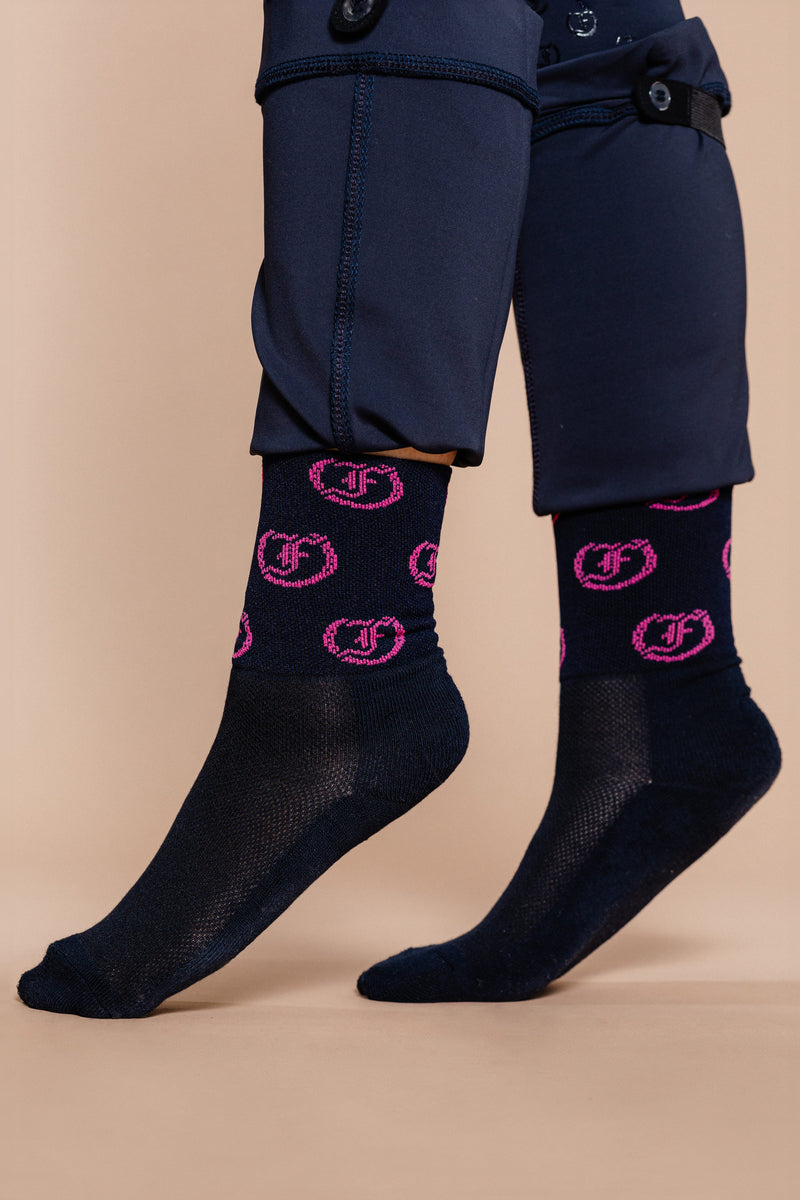 Navy socks with repeating pink circular Freedman's logo pattern, worn on feet with navy Jods.