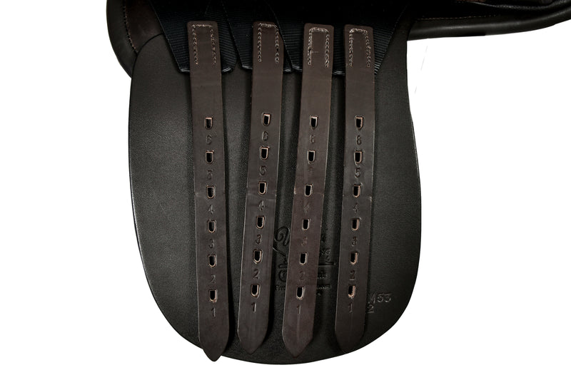 Close-up of a World Cup HP Cutback Saddle with dark brown stirrup leathers hanging down, shown against a white background.