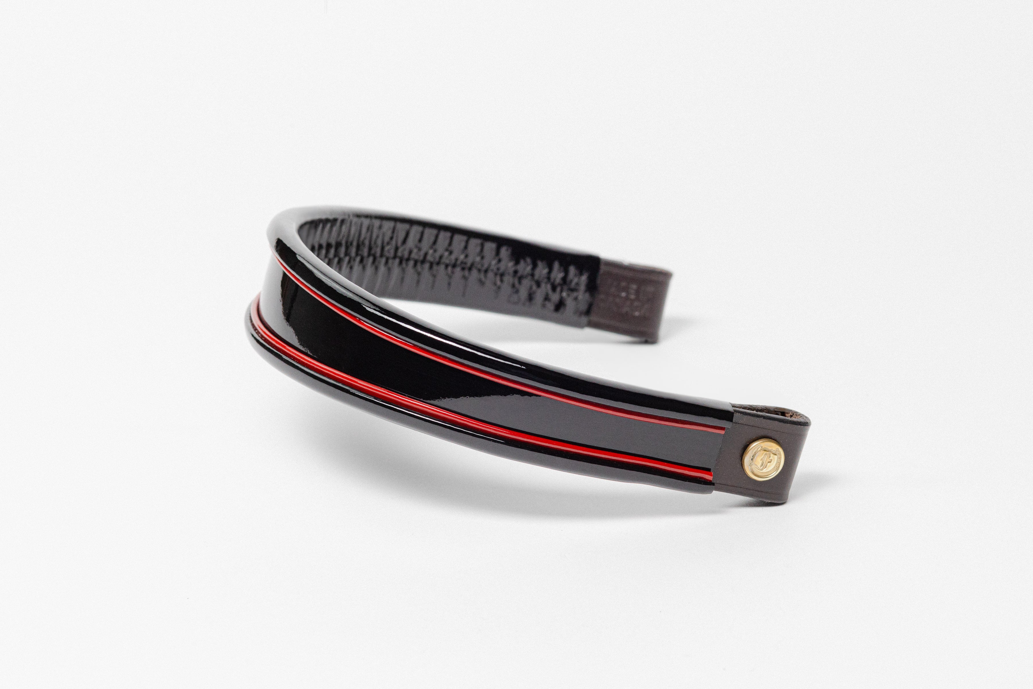 Black and red insert patent leather browband, wide tapered design, turned edge, angled view showing texture and leather ends.
