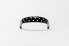 Black Patent Leather Browband with white dots, wide tapered design, polished brass Freedman logo buttons, and dark leather ends, frontal view.