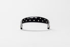 Black Patent Leather Browband with small white dots, wide tapered design, polished brass Freedman logo buttons, and dark leather ends, frontal view.