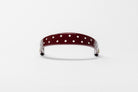 Burgundy Patent Leather Browband with small white dots, wide tapered design, polished brass Freedman logo buttons, and dark leather ends, frontal view.