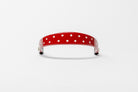 Red Patent Leather Browband with small white dots, wide tapered design, polished brass Freedman logo buttons, and dark leather ends, frontal view.