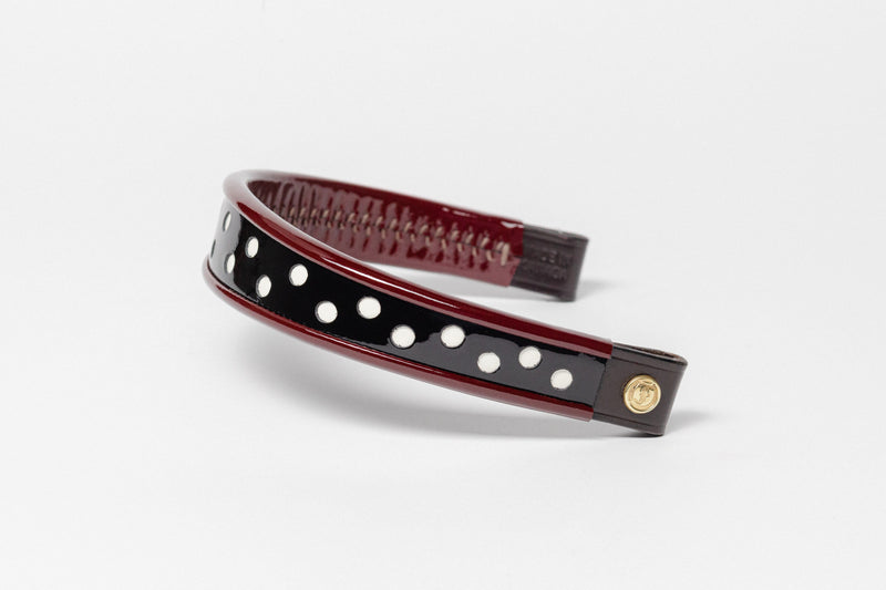 Wide Tapered 13" Turned Edge Browband, Burgundy with white polka dots, glossy finish, dark leather ends with gold button detail, shown on white background.