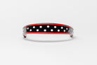 Red and white dot patent leather browband, wide tapered design, turned edge, dark leather ends with gold button, shown Front.